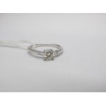 An 18ct White Gold Single Stone Diamond Ring, the brilliant cut stone four claw set between baguette