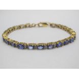 A Tanzanite and Diamond Set Bracelet, of uniform design, claw set throughout. *Ernest Jones