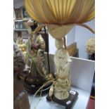 An Early XX Century Japanese Pottery Table Lamp, as a Geisha, a carved hardwood stand, another white