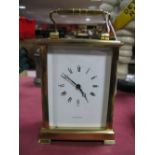 A XX Century Oversized Brass Carriage Clock by Shortland Bowen, with white enamel dial with Roman