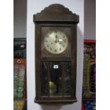 A 1940's Oak Cased Wall Clock, with silvered circular dial and glazed door.