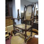 A XVII Century Style Walnut Armchair, the top rail with scroll decoration, caned back and seat,