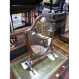 An XVIII Century Style Mahogany Dressing Mirror, with shaped supports, shield shaped mirror,