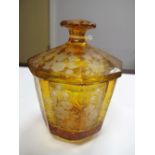 An Early XX Century Octagonal Amber Glass Jar and Cover, in the Moser style, with wheel cut floral