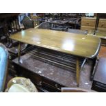 An Ercol Elm Coffee Table, shaped rectangular top, rounded ends, with spindle undertier.