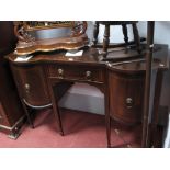 An Edwardian Mahogany Sideboard, with a central drawer, flanking bow fronted cupboards, on
