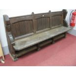 A XIX Century Pitch Pine Church Pew, with three panelled back shaped ends, on column supports.