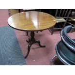 An XVIII Century Mahogany Pedestal Table, with circular top and turned pedestal, on cabriole legs.