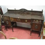 An Early XX Century Mahogany Bow Fronted Sideboard, with a shaped low back, turned finial's, applied