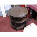 A 1920's Oak Three Tier Circular Topped Coffee Table/Bookcase, on chamfered supports, on castors,