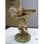 A Royal Worcester "Hadley" Sweetmeat Dish, modelled in the form of a boy carrying a large basket