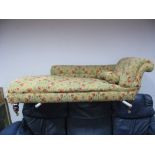 A Late XIX Century Chaise Longue, upholstered in floral decoration, on turned legs.