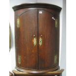 An XVIII Century Oak Bow Fronted Corner Cupboard, with reeded sides and three internal shelves.