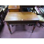 A XIX Century Mahogany Tea Table, with a rectangular top, swivel action on turned legs.