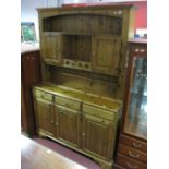 A Ducal Dresser, the rack with a stepped pediment, twin panelled cupboard doors, reeded sides, the