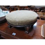 A XIX Century Rosewood Circular Shaped Footstool, with upholstered top, on scroll feet.