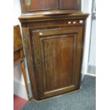 An Early XIX Century Oak and Mahogany Flat Fronted Corner Cupboard, with three internal shelves.