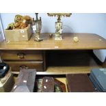 An Ercol Elm Coffee Table, fitted with two short drawers and undertier, on castors.