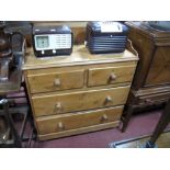 A XIX Century Pine Chest, of two short and two long drawers, having turned knobs, shaped gallery