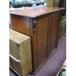 A Mid XIX Century Mahogany Cupboard, the top with moulded edge over flanking scroll shaped brackets,