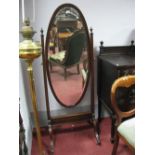 An Early XX Century Mahogany Cheval Mirror, with an oval mirror tapering supports, with finials,