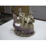 A Hilary Brock Pottery Figure Group, as a couple in a rowing boat, on top of a whale.