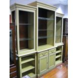 A XX Century Painted Breakfront Bookcase, moulded cornice over open adjustable glass shelving,