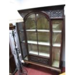 An Early XX Century Mahogany Display Cabinet, having fretwork carved upper panels, arched astragal