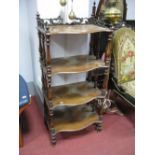 A Mid XIX Century Walnut Four Tier What Not, with three-quarter scroll shaped gallery (damage) on