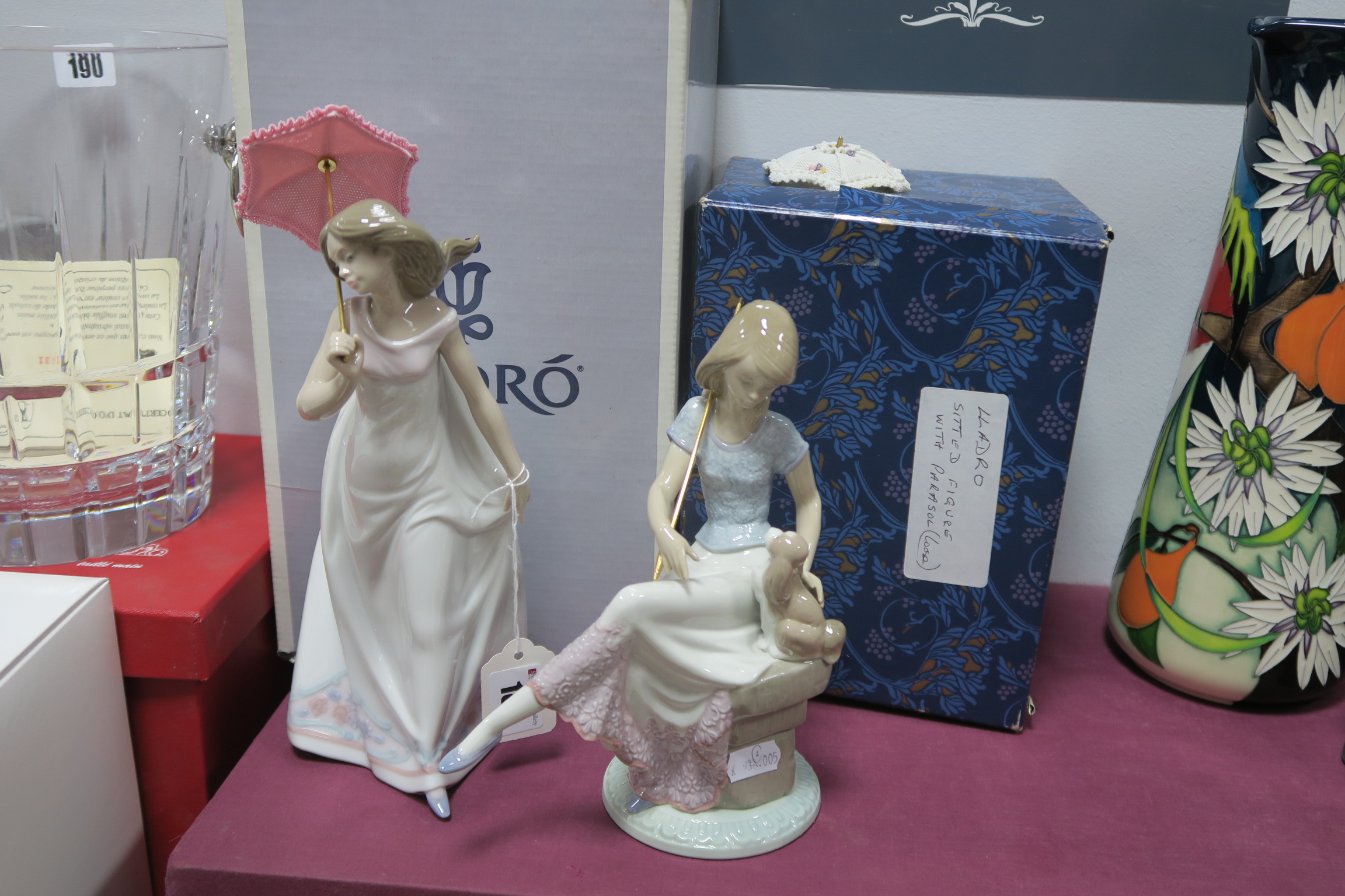 Lladro Pottery 'Afternoon Promenade', of seated lady and dog, both with parasols and two boxes.