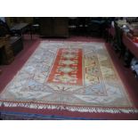 A Turkish Tasselled Wool Carpet, having five central motifs on orange rectangular panel within a