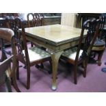 An Early XX Century Walnut Draw Leaf Dining Table, on cabriole legs;