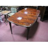 A Mahogany Oval Shaped Dining Table, on tapering legs, spade feet, (one extra leaf).