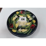 A Moorcroft Pottery Coaster, decorated in the Ankerwycke Yew design by Emma Bossons, shape 780/4,