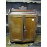 An Early XX Century Mahogany Table Top Cabinet, with a 3/4 gallery back, panelled doors, two