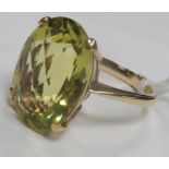 A Modern Single Stone Dress Ring, oval four claw set, high between plain shoulders.