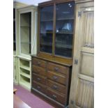 A Late XIX Century Oak Bookcase, twin glazed door with interior shelving over two banks of four
