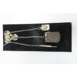 An Electroplated Chatelaine, the shaped panel with hinged clip, of openwork foliate design, with