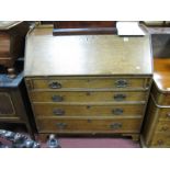An Early XIX Century Oak Bureau, with a ¾ gallery, fall front, fitted interior, four long drawers,