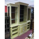 A Villeroy & Boch Painted Breakfront Bookcase, moulded cornice over open adjustable glass