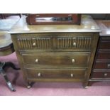 A 1920's Oak Chest of Drawers, moulded edge over two short drawers with linen fold decoration, above