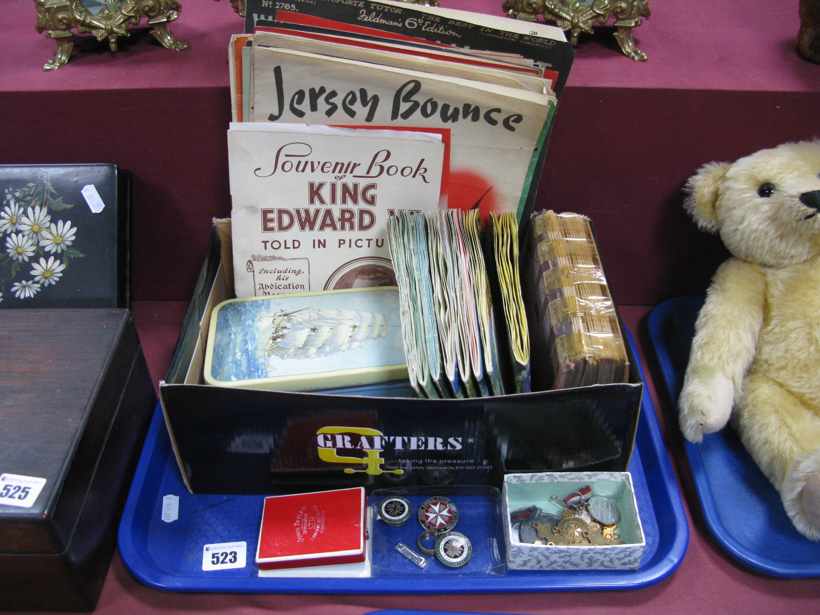 Cigarette and Trade Cards, sheet music, silver first aid and other badges, medals:- One Tray