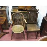 A XIX Century Yew and Elm Wheel Back Armchair, (damaged) and an oak hall chair. (2)