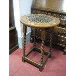 A 1920's Oak Circular Table, with a carved top, on barley twist and block supports.