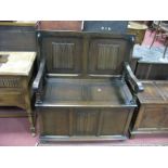 A Mid XX Century Oak Monks Bench, with linen fold back and fascia.