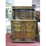 An Oak Court Cupboard, of narrow proportions, with knulled top and drawers, carved cup and cover