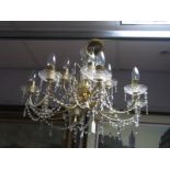 A Gilt Metal Eight Branch Chandelier, with faceted lustre drop and connectors.