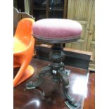 A XIX Century Rosewood Revolving Piano Stool, with upholstered top, turned pedestal, on cabriole