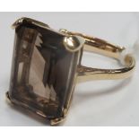 A Large 9ct Gold Single Stone Dress Ring, rectangular four claw set, between plain shoulders.