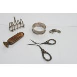 A Miniature Five Bar Toast Rack, sewing scissors, miniature pistol charm, freestanding vesta.